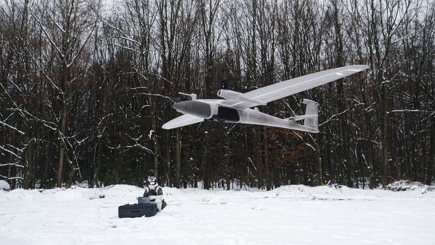 BotBit fixed-wing UAV in flight over snowy terrain — Autoabode defence drone lab India